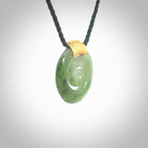 Hand carved British Columbian jade koru pendant. Delivered to you on a hand plaited manuka green cord which is adjustable. Free delivery worldwide.